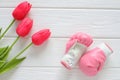 Tulips flowers and boxing gloves on wooden background, femenism concept