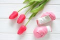 Tulips flowers and boxing gloves on wooden background, femenism concept