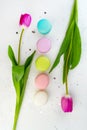 Tulips flowers and macaroons on grey background. Flat Lay. Spring floral concept. French dessert still life Royalty Free Stock Photo