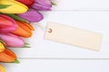 Tulips flowers in spring or mother's day with card on a wooden b Royalty Free Stock Photo