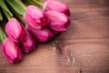 Tulips flowers on wooden table.