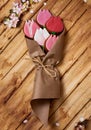 Tulips in kraft paper on a wooden background