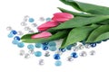 Tulips laying on white table with glass beads Royalty Free Stock Photo