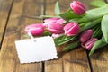 Tulips on old brown wooden table with a Stickies Royalty Free Stock Photo