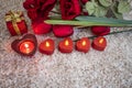 Tulips, roses flower and heart shaped candle on an snow like background