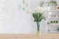 Tulips in a vase on a wooden table. Scandinavian interior Royalty Free Stock Photo