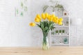 Tulips in a vase on a wooden table. Scandinavian interior Royalty Free Stock Photo