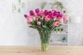 Tulips in a vase on a wooden table. Scandinavian interior Royalty Free Stock Photo