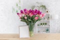 Tulips in a vase on a wooden table. Scandinavian interior. Mockup Royalty Free Stock Photo