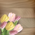 Tulips on wood background