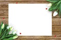 Tulips on wooden background with space for message. Mother`s Day background. Flowers on rustic table for March 8