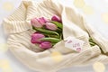 Tulips wrapped in a warm wool sweater with love words on paper label