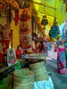 stock photo of books,goddess face mural, cloths,cotton garland, cane basket items used for