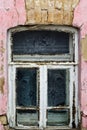 A tulle curtain in the window of an old dilapidated house Royalty Free Stock Photo