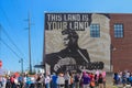 Tulsa OK 3-24-2019 Protestors march down street by Woody Guthrie Museum in Tulsa