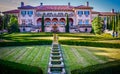 The formal gardens behind Philbrook Museum on a summer day with people enjoying the scenery and the pink