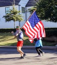 Runner with American Flag in Tulsa Run down Peoria Avenue in - close-up
