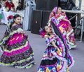 Tulsa USA - Beautiful young Hispanic girls dance at street festival in beautiful colorful dresses with flowers in their