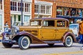 1930 Cadillac Series 355C steampunk limo with young man videotaping wheel on street in Arts District Tulsa