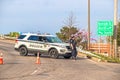 Tulsa USA - Tulsa cop leans on front of his police car blocking overpass with orange cones on overcast day with damaged Royalty Free Stock Photo