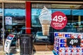 2018_06_09_Tulsa USA Glass Front of convience store with reflections trash can stack of bottled water and giant ice cream cone