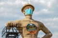 Iconic Golden Driller - Giant statue near Route 66 in Oklahoma wearing facial mask during pandemic
