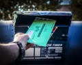 2020_10_02_Tulsa USA Man depositing Official Election Ballot into old banged up drive up mailbox with blurred background