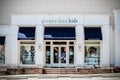 Pottery bar kids store with statue of little girl ready outside and Ready for School display in window