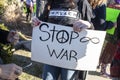 01-04-2020 Tulsa USA Protestor in impeach tee-shirt hold stop war sign in crowd