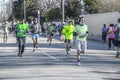 Runners in green at St. Patricks Day Parade down Peoria Ave in Tulsa Oklahoma