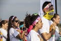 4-6-2019 Tulsa USA Woman dressed for Color Run puts hand over heart during playing of National Anthem with crowd around -