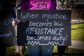 Tulsa USA Woman in pink Notorious RBG teeshirt holds handmade sigen - When injustice becomes law RESISTANCE becomes