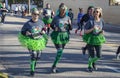 Tulsa USA 3 - 16 - 2019 Women jogging in in St Patrick`s Day Run wearing green tutu skirts and official tee-shirts and other gree