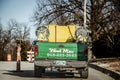 Yard Care truck with plastic tank and hoses on back with company name Weed Man and phone number drives down Royalty Free Stock Photo