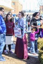 Young Woman in historical dress at Womens March hold sign saying Same fight Different Century