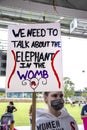 Tulsa USA - Young woman in mask holds sign at Reproductive Freedom rally at park - We need to talk about the Elephant