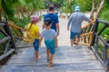 TULUM, MEXICO - JANUARY 10, 2018: Unidentified people walking over a wooden brindge in an ecological path in Mayan ruins Royalty Free Stock Photo