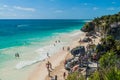 TULUM, MEXIO - FEB 29, 2016: Tourists at the beach under the ruins of the ancient Maya city Tulum, Mexi Royalty Free Stock Photo