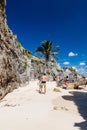 TULUM, MEXIO - FEB 29, 2016: Tourists at the beach under the ruins of the ancient Maya city Tulum, Mexi Royalty Free Stock Photo