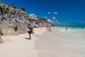 TULUM, MEXIO - FEB 29, 2016: Tourists at the beach under the ruins of the ancient Maya city Tulum, Mexi Royalty Free Stock Photo