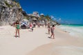TULUM, MEXIO - FEB 29, 2016: Tourists at the beach under the ruins of the ancient Maya city Tulum, Mexi Royalty Free Stock Photo