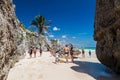 TULUM, MEXIO - FEB 29, 2016: Tourists at the beach under the ruins of the ancient Maya city Tulum, Mexi Royalty Free Stock Photo