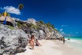 TULUM, MEXIO - FEB 29, 2016: Tourists at the beach under the ruins of the ancient Maya city Tulum, Mexi Royalty Free Stock Photo