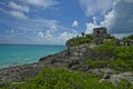 The Tulum temple sits high on a rocky cliff overlooking the turquoise water along the coast of Quintana Roo.