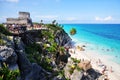 Tulum, Yucatan/Mexico - August 03, 2011: Lots of Tourists at paradise beach with El Castillo Temple in the background at Mayan