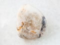 tumbled baryte stone on white marble