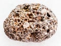 tumbled brown pumice stone on white marble Royalty Free Stock Photo