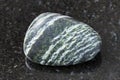 tumbled Chrysotile asbestos gemstone on dark Royalty Free Stock Photo