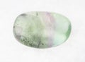 tumbled fluorite (fluorspar) gemstone on white