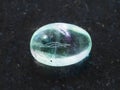 tumbled Fluorite gemstone on dark background